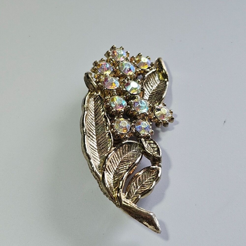 Gold tone aurora borealis brooch
